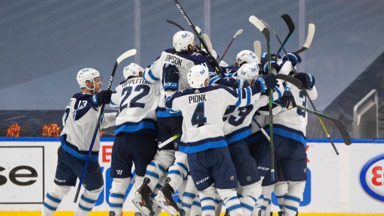 Winnipeg Jets players celebrate the win over the Edmonton Oilers during overtime NHL Stanley Cup playoff action in Edmonton on Friday, May 21, 2021. (Jason Franson/CP)