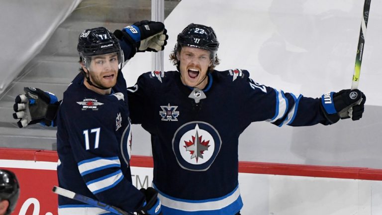 Winnipeg Jets' Mason Appleton (22) celebrates his goal with teammate Adam Lowry (17) during first period NHL Stanley Cup playoff action against the Edmonton Oilers, in Winnipeg on Monday, May 24, 2021. (Fred Greenslade/CP)