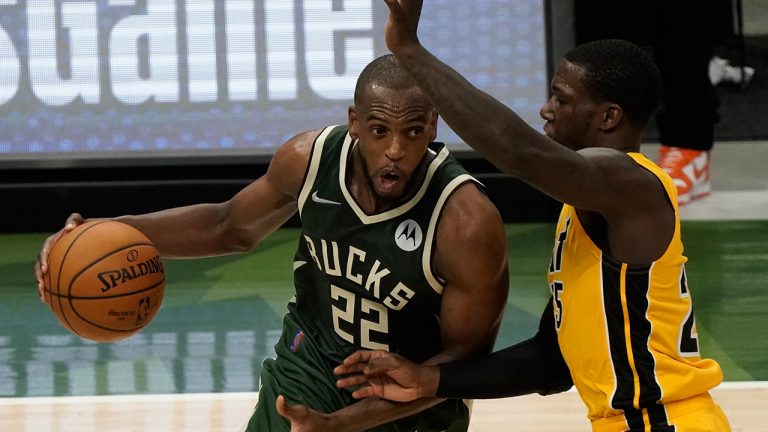 Milwaukee Bucks' Khris Middleton drives past Miami Heat's Kendrick Nunn during the second half of Game 1 of their NBA basketball first-round playoff series Saturday, May 22, 2021, in Milwaukee. (Morry Gash/AP)