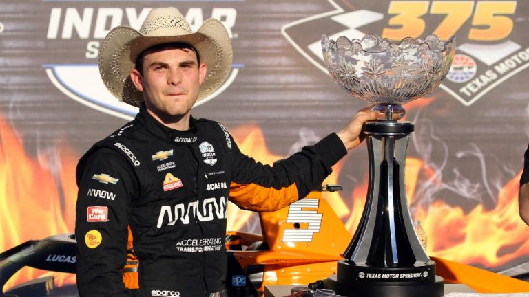 Pato O'Ward poses with the trophy as he celebrates his victory at an IndyCar Series auto race at Texas Motor Speedway on Sunday, May 2, 2021, in Fort Worth, Texas. (Richard W. Rodriguez/AP)