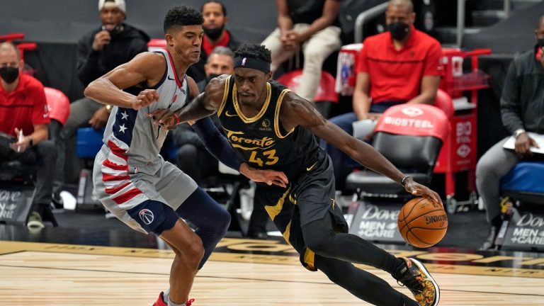 Toronto Raptors forward Pascal Siakam (43) drives around Washington Wizards forward Chandler Hutchison (1) during the first half of an NBA basketball game Thursday, May 6, 2021, in Tampa, Fla. (AP Photo/Chris O'Meara)