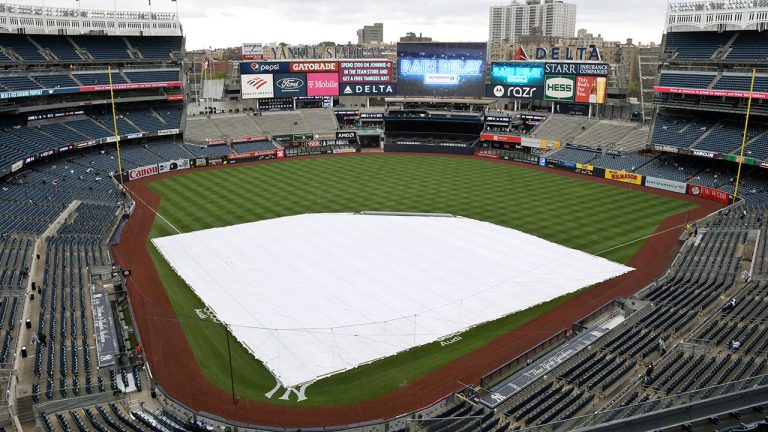 The tarp covers the infield as a rain delays the start of the New York Yankees' baseball game at Yankee Stadium in New York. (Bill Kostroun/AP) 