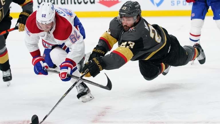 Vegas Golden Knights defenceman Alec Martinez (23) lunges for the puck next to Montreal Canadiens left wing Artturi Lehkonen (62) during the second period in Game 2 of an NHL hockey Stanley Cup semifinal playoff series, Wednesday, June 16, 2021, in Las Vegas. (John Locher / AP) 