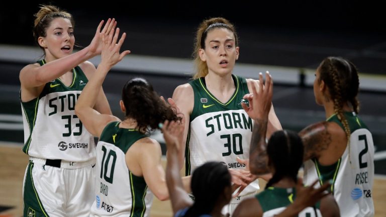 Seattle Storm players, including Katie Lou Samuelson (33) and Breanna Stewart (30), celebrate a score against the Atlanta Dream. (Ben Margot/AP)