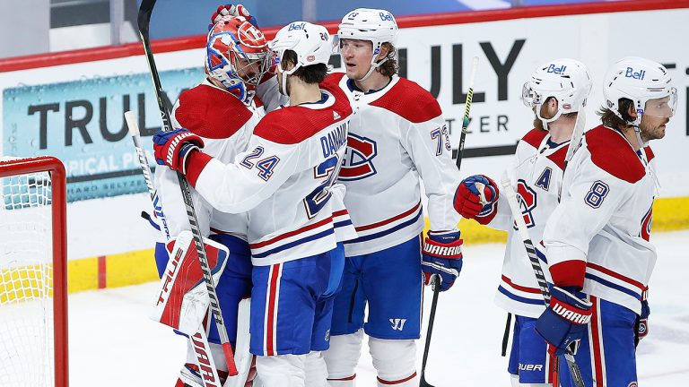 Montreal Canadiens' Phillip Danault (24) and Tyler Toffoli (73) celebrate with goaltender Carey Price (31) after defeating the Winnipeg Jets in NHL playoff action in Winnipeg on Friday, June 4, 2021. (John Woods/CP)