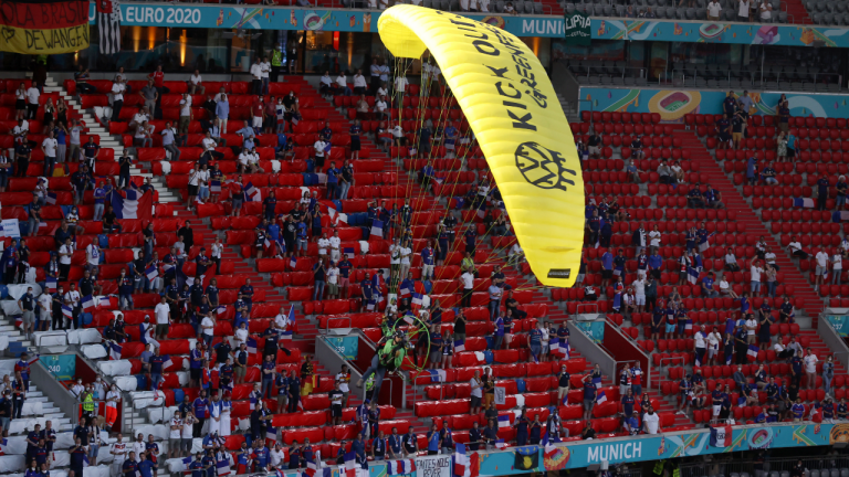 A Greenpeace paraglider lands in the stadium prior to the Euro 2020 soccer championship group F match between France and Germany at the Allianz Arena stadium in Munich, Tuesday, June 15, 2021. (Ctivist Alexander Hassenstein / AP) 