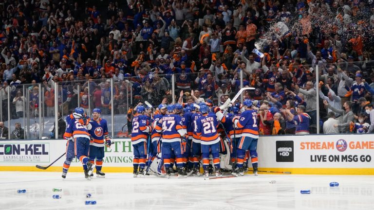 Fans cheer as the New York Islanders celebrates after Game 6 of an NHL hockey semifinals against the Tampa Bay Lightning Wednesday, June 23, 2021, in Uniondale, N.Y. The Islanders won 3-2. (AP Photo/Frank Franklin II) 
