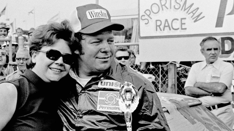 Jack Ingram gives his wife, Aline, a big hug after accepting the trophy from his victory in the Permatex 300 auto race at Daytona International Speedway in 1975. (AP Photo)