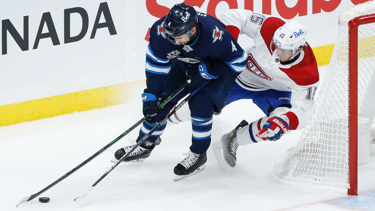 Montreal Canadiens' Jesperi Kotkaniemi (15) chases Winnipeg Jets' Neal Pionk (4) around the net during second period NHL Stanley Cup hockey action in Winnipeg, Wednesday, June 2, 2021. (John Woods / CP)