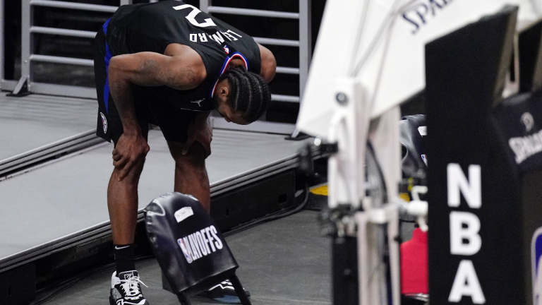 Los Angeles Clippers forward Kawhi Leonard holds his knee after stepping awkwardly during the second half in Game 4 of a second-round NBA basketball playoff series against the Utah Jazz Monday, June 14, 2021, in Los Angeles. (Mark J. Terrill / AP) 