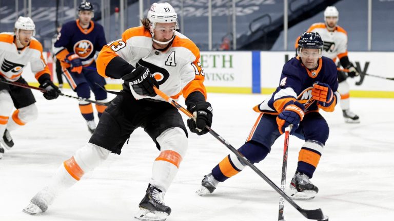 Philadelphia Flyers center Kevin Hayes (13) shoots the puck past New York Islanders defenseman Andy Greene during the first period of an NHL hockey game Saturday, March 20, 2021, in Uniondale, N.Y. (Adam Hunger/AP)