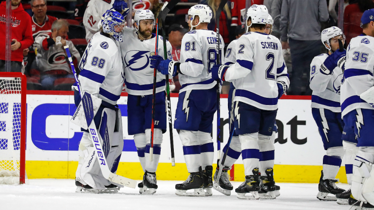 Tampa Bay Lightning players congratulate goaltender Andrei Vasilevskiy (88) following the team's 2-1 win over the Carolina Hurricanes in Game 2 of an NHL hockey Stanley Cup second-round playoff series in Raleigh, N.C., Tuesday, June 1, 2021. (Karl B DeBlaker / AP)