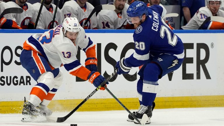 New York Islanders centre Mathew Barzal (13) knocks the puck away from Tampa Bay Lightning centre Blake Coleman (20). (Chris O'Meara/AP)