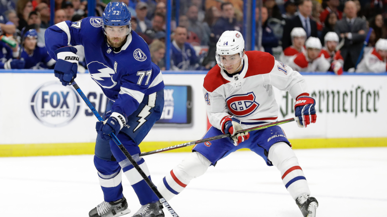 In this March 5, 2020, file photo, Tampa Bay Lightning defenseman Victor Hedman (77) breaks up a pass intended for Montreal Canadiens center Nick Suzuki (14) during the first period of an NHL hockey game in Tampa, Fla. (Chris O'Meara / AP)