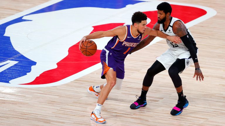 Los Angeles Clippers' Paul George defends against Phoenix Suns' Devin Booker. (Kevin C. Cox/Pool via AP) 
