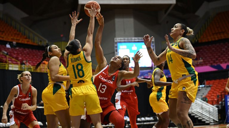 The Canadian women's basketball team vying for the ball against Brazil. (FIBA)