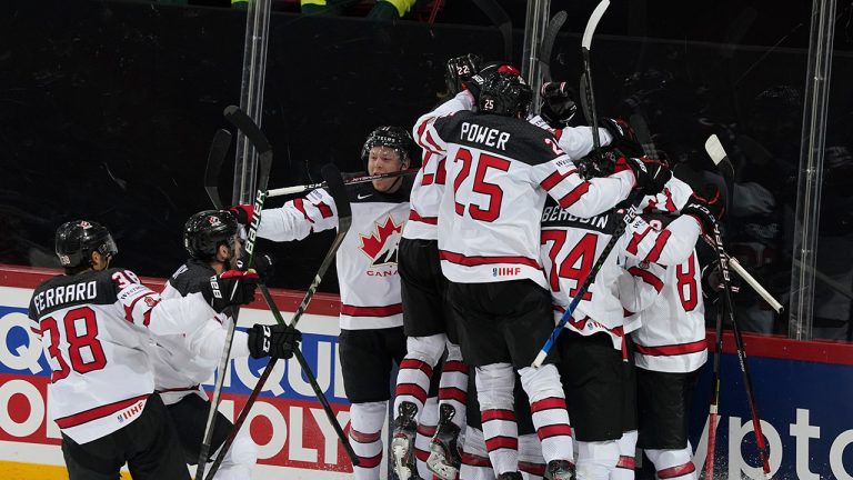 Canada team players celebrate a victory after the Ice Hockey World Championship quarterfinal match between Russia and Canada at the Olympic Sports Center in Riga, Latvia, Thursday, June 3, 2021. (Roman Koksarov/AP) 