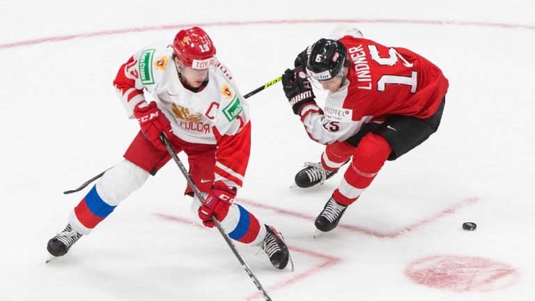 Russia's Vasili Podkolzin (19) and Austria's Luis Lindner (15) battle for the puck during third period IIHF World Junior Hockey Championship action in Edmonton on Tuesday, December 29, 2020. (Jason Franson/CP)