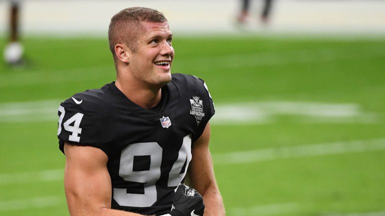 Carl Nassib #94 of the Las Vegas Raiders flexes while smiling during warmups. (Ethan Miller/Getty Images)