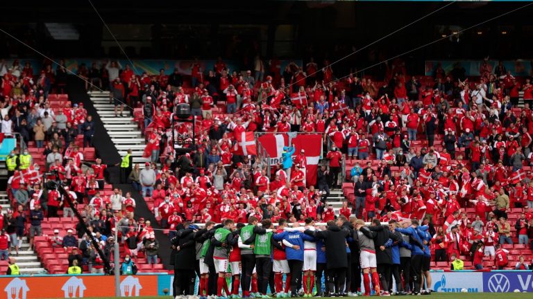 Danish players gather on the pitch during the Euro 2020 group B match between Denmark and Finland at Parken stadium in Copenhagen, Denmark, Saturday, June 12, 2021. (Friedemann Vogel/Pool via AP) 