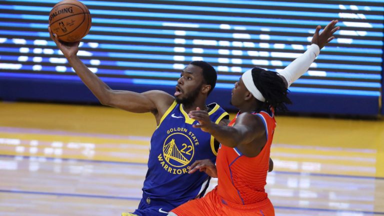 Golden State Warriors' Andrew Wiggins, left, shoots against Oklahoma City Thunder's Luguentz Dort during the first half of an NBA basketball game in San Francisco, Saturday, May 8, 2021. (Jed Jacobsohn/AP) 
