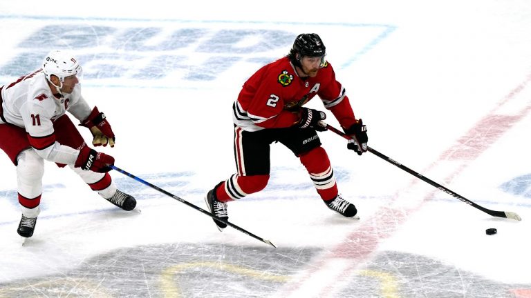 Chicago Blackhawks' Duncan Keith, right, looks to pass past Carolina Hurricanes' Jordan Staal during the second period of an NHL hockey game in Chicago, Thursday, Feb. 4, 2021. (Nam Y. Huh/AP) 