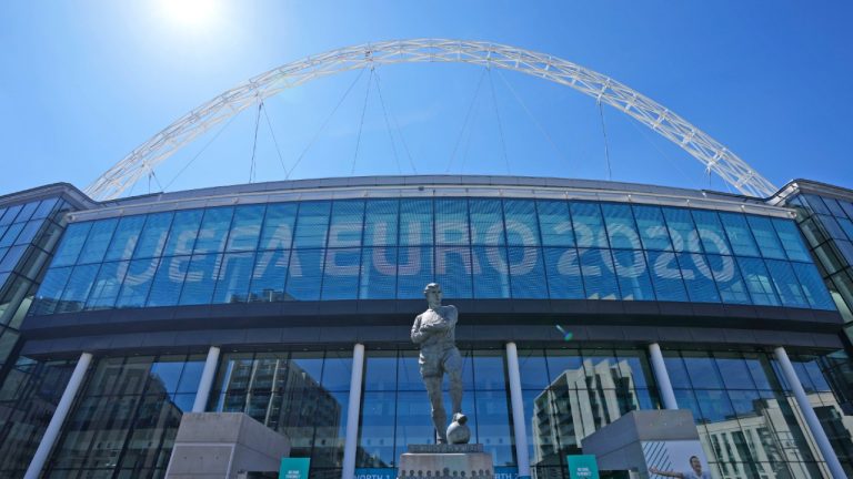 The statue of England's football legend Bobby Moore stands in front of the UEFA Euro sign at Wembley stadium entrance in the build-up to the upcoming Euro 2020 soccer championship in London, Wednesday, June 9, 2021. Euro 2020 kicks-off on Friday June 11 when Italy face Turkey in Rome. (Frank Augstein/AP) 