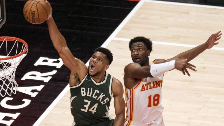 Milwaukee Bucks forward Giannis Antetokounmpo scores past Atlanta Hawks forward Solomon Hill on April 25, 2021. (AP Photo/Ben Gray)