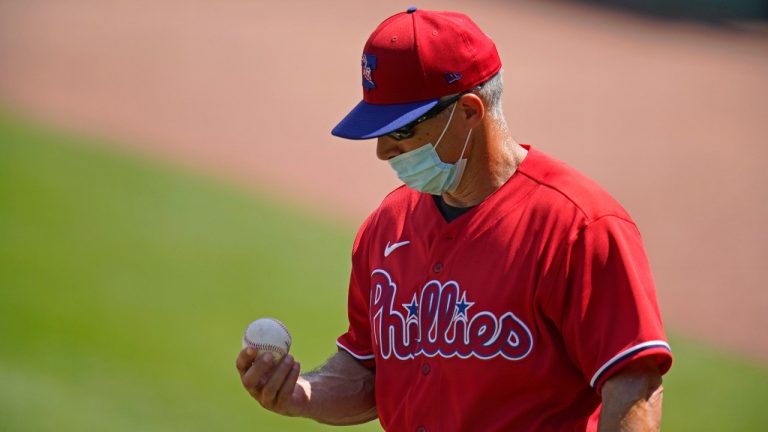 Philadelphia Phillies manager Joe Girardi looks at the ball that hit Didi Gregorius during the second inning of the team's spring training exhibition baseball game against the Toronto Blue Jays in Clearwater, Fla., Tuesday, March 16, 2021. (Gene J. Puskar/AP)