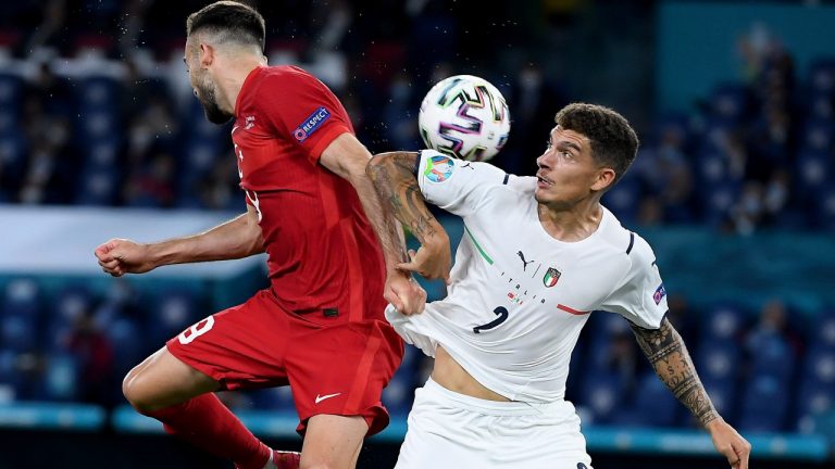 Turkey's Kenan Karaman, left, and Italy's Giovanni Di Lorenzo challenge for the ball during the Euro 2020 soccer championship group A match between Turkey and Italy at the Olympic stadium in Rome, Friday, June 11, 2021. (Ettore Ferrari/Pool via AP)