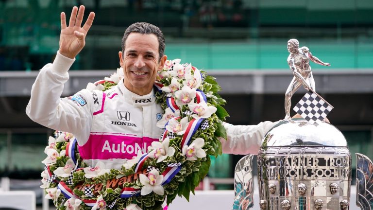 Helio Castroneves of Brazil, winner of the 2021 Indianapolis 500 auto race, poses during the traditional winners photo session at the Indianapolis Motor Speedway in Indianapolis, Monday, May 31, 2021. (Michael Conroy/AP) 