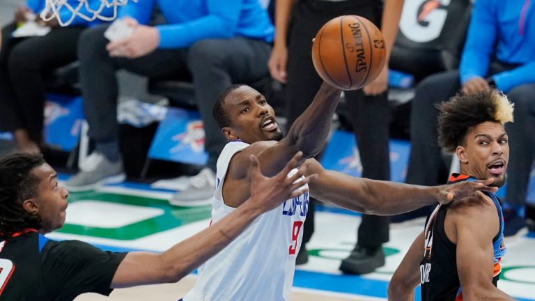 Los Angeles Clippers center Serge Ibaka (9) reaches for a rebound between Oklahoma City Thunder center Moses Brown (9) and forward Charlie Brown Jr., right, in the second half of an NBA basketball game Sunday, May 16, 2021, in Oklahoma City. (Sue Ogrocki/AP) 