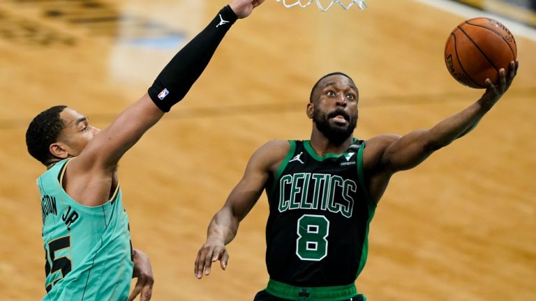 Boston Celtics guard Kemba Walker (8) shoots past Charlotte Hornets forward P.J. Washington during the second half on Sunday, April 25, 2021, in Charlotte, N.C. (Chris Carlson/AP) 