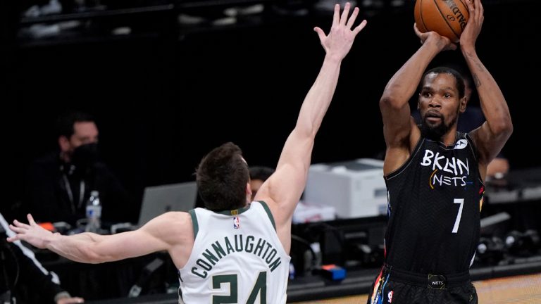 Brooklyn Nets forward Kevin Durant (7) shoots as Milwaukee Bucks guard Pat Connaughton (24) defends. (Kathy Willens/AP) 
