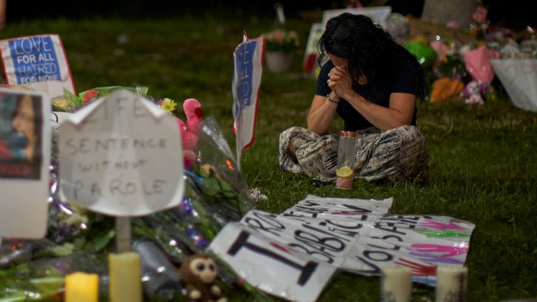 A woman sits and weeps at the scene of Sunday's hate-motivated vehicle attack in London, Ont. (Geoff Robins/CP)