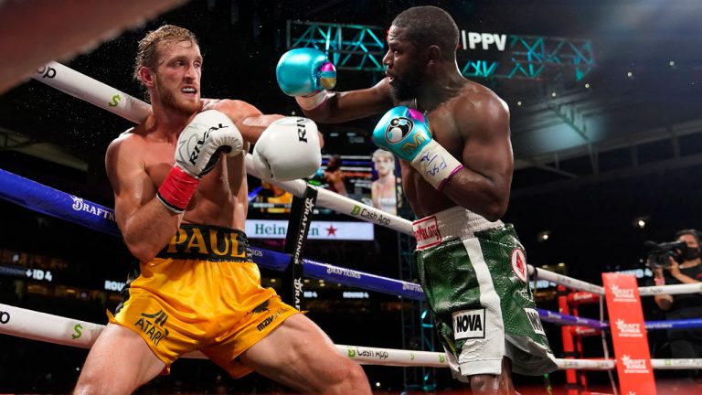 Floyd Mayweather, right, throws a punch at Logan Paul, left, during an exhibition boxing match at Hard Rock Stadium. (Lynne Sladky/AP) 