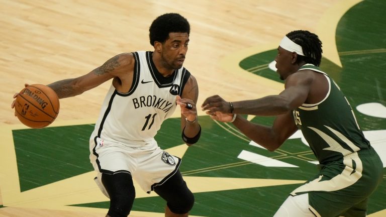 Brooklyn Nets' Kyrie Irving tries to drive past Milwaukee Bucks' Jrue Holiday during the second half of Game 3 of the NBA Eastern Conference basketball semifinals game Thursday, June 10, 2021, in Milwaukee. (Morry Gash/AP)