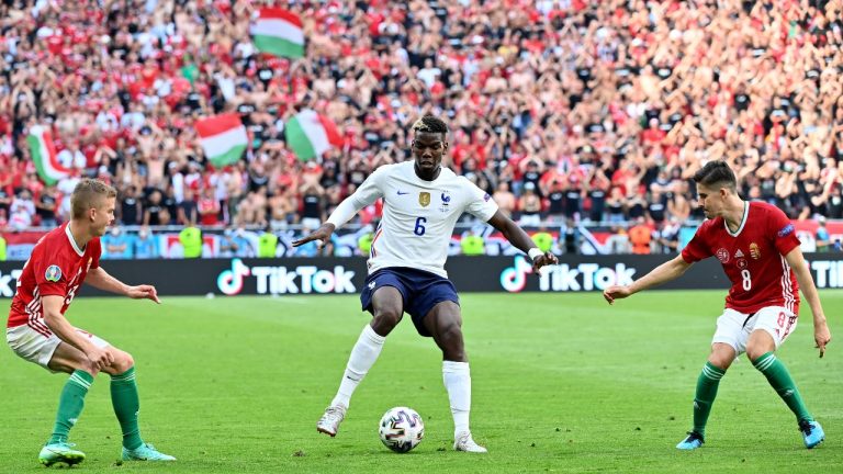 Hungary's Adam Nagy, right, and Hungary's Nemanja Nikolic, left, try to defend France's Paul Pogba during the Euro 2020 Group F match between Hungary and France at the Ferenc Puskas stadium in Budapest, Hungary Saturday, June 19, 2021. (Tibor Illyes/Pool via AP) 