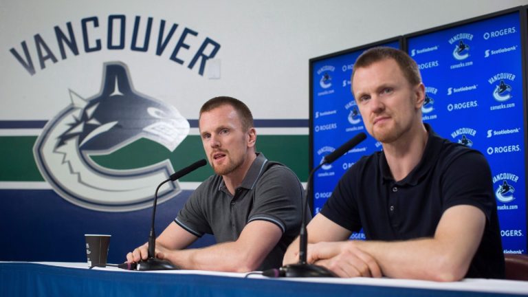 Vancouver Canucks' Daniel Sedin, left, and his twin brother Henrik Sedin, both of Sweden, listen during an end of season news conference held by the NHL hockey team, in Vancouver, B.C., on Monday April 9, 2018. (Darryl Dyck/CP)