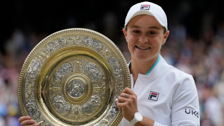 Australia's Ashleigh Barty poses with the trophy for the media after winning the women's singles final after defeating the Czech Republic's Karolina Pliskova on day twelve of the Wimbledon Tennis Championships in London, Saturday, July 10, 2021. (Kirsty Wigglesworth/AP)