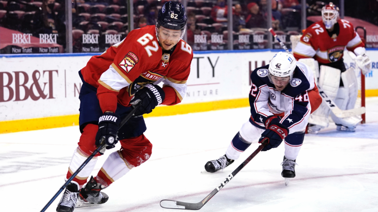 Florida Panthers defenceman Brandon Montour (62) and Columbus Blue Jackets center Alexandre Texier (42) go for the puck during the third period of an NHL hockey game, Monday, April 19, 2021, in Sunrise, Fla. (Lynne Sladky / AP) 