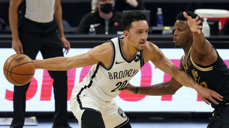 Brooklyn Nets guard Landry Shamet (20) drives around Toronto Raptors guard Kyle Lowry (7) during the first half of an NBA basketball game. (Chris O'Meara/AP)