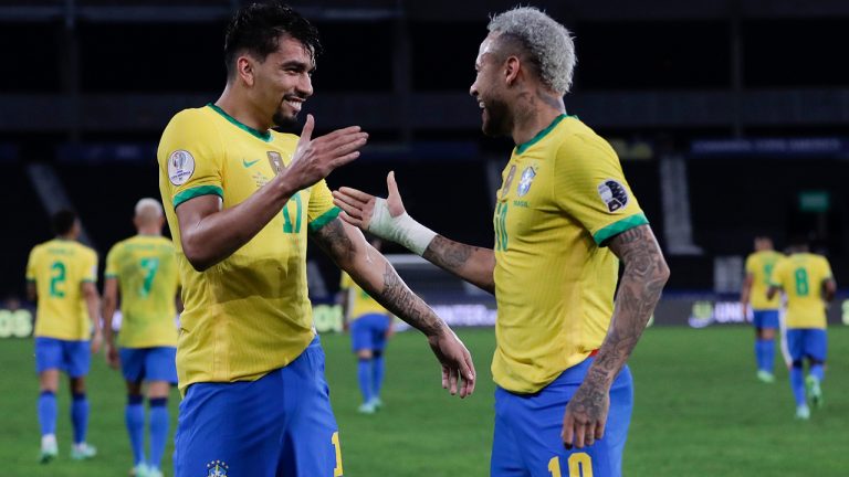 Brazil's Lucas Paqueta, left, celebrates with teammate Neymar after scoring his side's opening goal against Peru during a Copa America semifinal soccer match at Nilton Santos stadium in Rio de Janeiro, Brazil, Monday, July 5, 2021. (Silvia Izquierdo/AP)