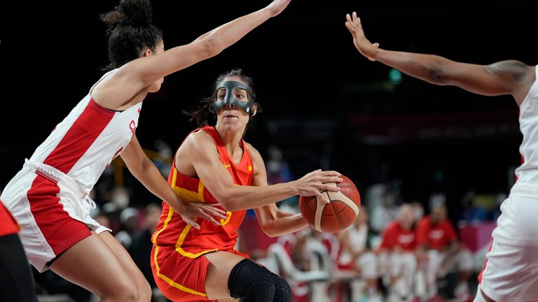 Spain's Cristina Ouvina (5), center, drives past Canada's Kia Nurse (5), left, during women's basketball preliminary round game at the 2020 Summer Olympics, Sunday, Aug. 1, 2021, in Saitama, Japan. (Eric Gay/AP)