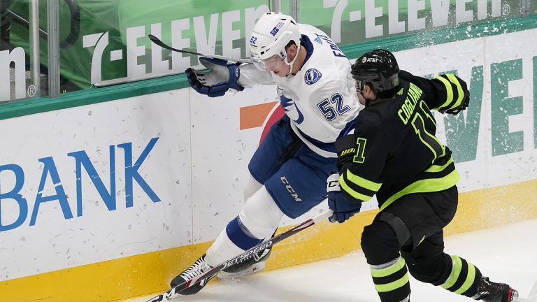 Tampa Bay Lightning defenseman Cal Foote (52) and Dallas Stars center Andrew Cogliano (11) compete for control of the puck during the second period of an NHL hockey game. (Tony Gutierrez/AP)