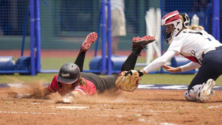 Canada's Joey Lye, left, is tagged by United States' Aubree Munro at home plate during the softball game between the United States and Canada at the 2020 Summer Olympics, Thursday, July 22, 2021, in Fukushima , Japan. (Jae C. Hong/AP)