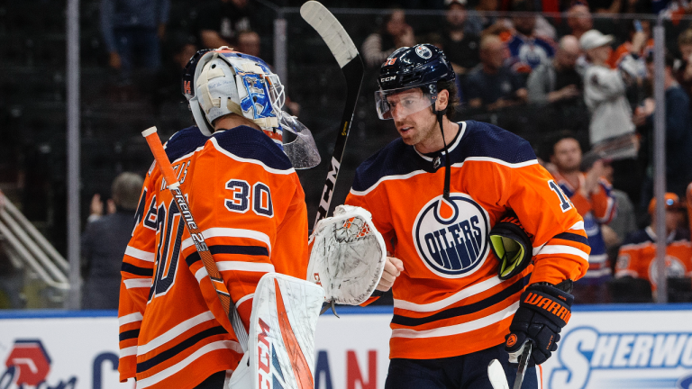 Edmonton Oilers' goalie Dylan Wells (30) and James Neal (18) celebrate the win over the Winnipeg Jets following NHL preseason action in Edmonton, Monday, Sept. 16, 2019. (Jason Franson / CP)