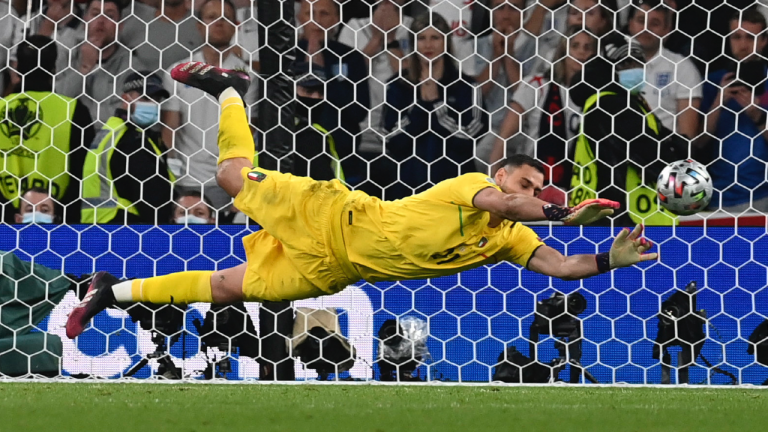 Italy's goalkeeper Gianluigi Donnarumma makes a save against England's Jadon Sancho during penalty shootout of the Euro 2020 soccer championship final match between England and Italy at Wembley Stadium in London, Sunday, July 11, 2021. (Paul Ellis/Pool via AP) 