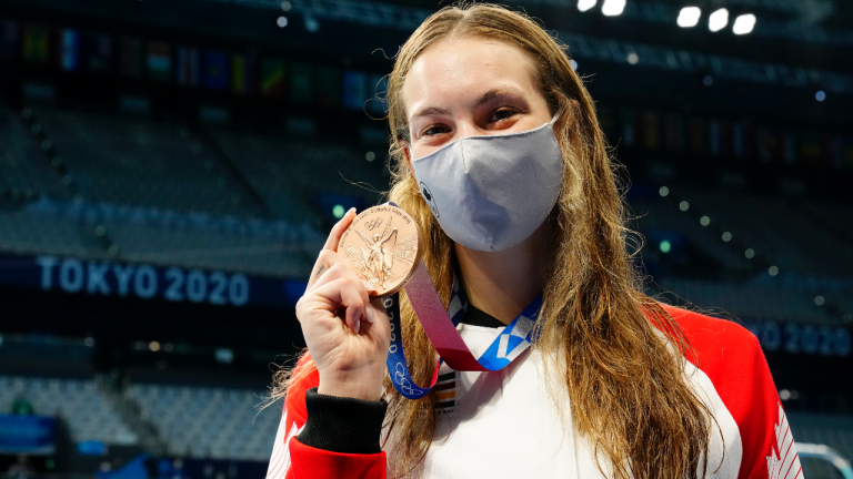 Canada's Penny Oleksiak shows off her bronze medal won in the women's 200m freestyle final event during the Tokyo Summer Olympic Games, in Tokyo, Wednesday, July 28, 2021. (Frank Gunn / CP)