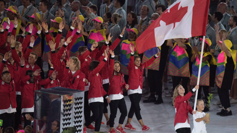 Rosie MacLennan carries the flag as she leads Canada into the opening ceremonies for the 2016 Summer Olympics Friday August 5, 2016 in Rio de Janeiro, Brazil. (Frank Gunn / CP)